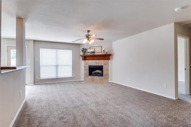 a view of an empty room with a fireplace