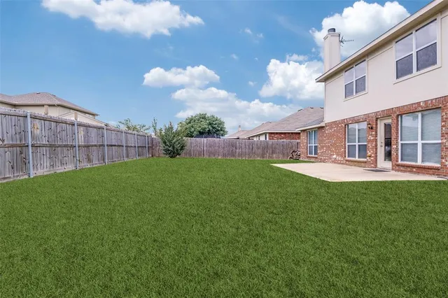 a view of a house with a backyard and a backyard