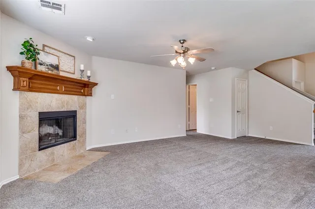 a view of empty room with a fireplace and fan