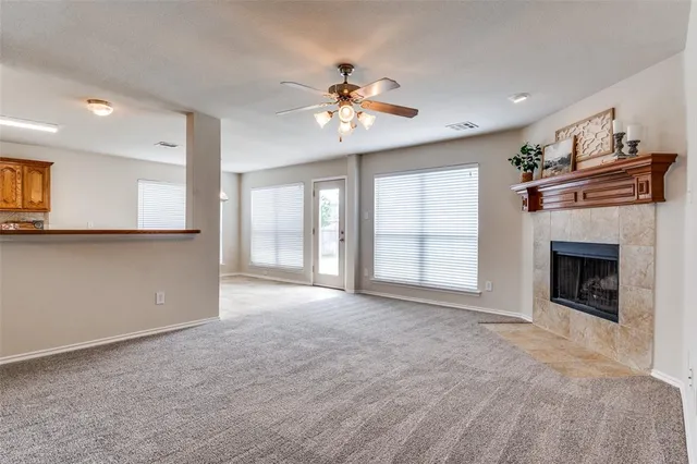 a view of an empty room with a fireplace and a window