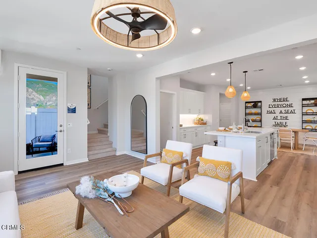 a living room with furniture and kitchen view