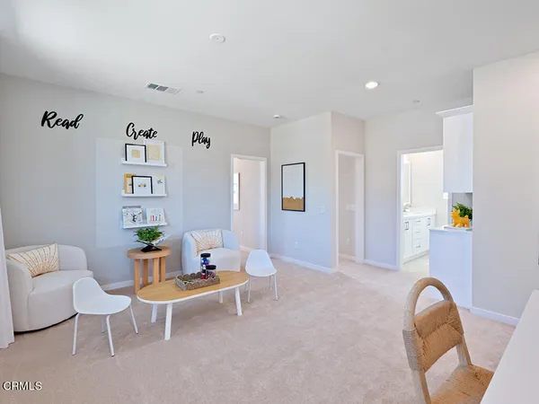 a living room with furniture and white walls