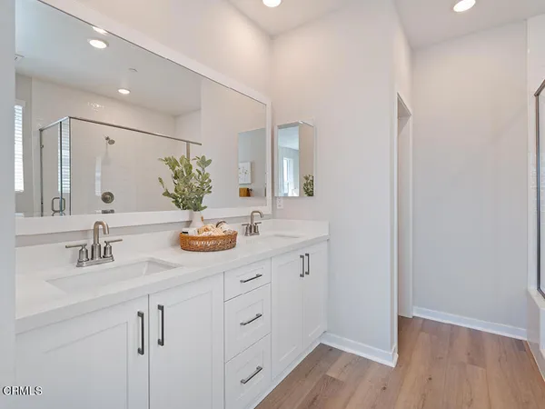 a bathroom with a double vanity sink and mirror