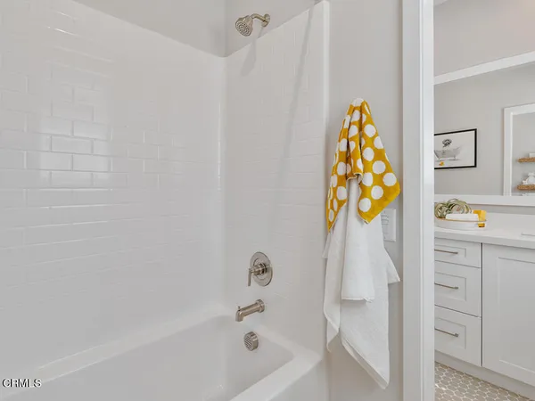 a bathroom with a bathtub and a shower