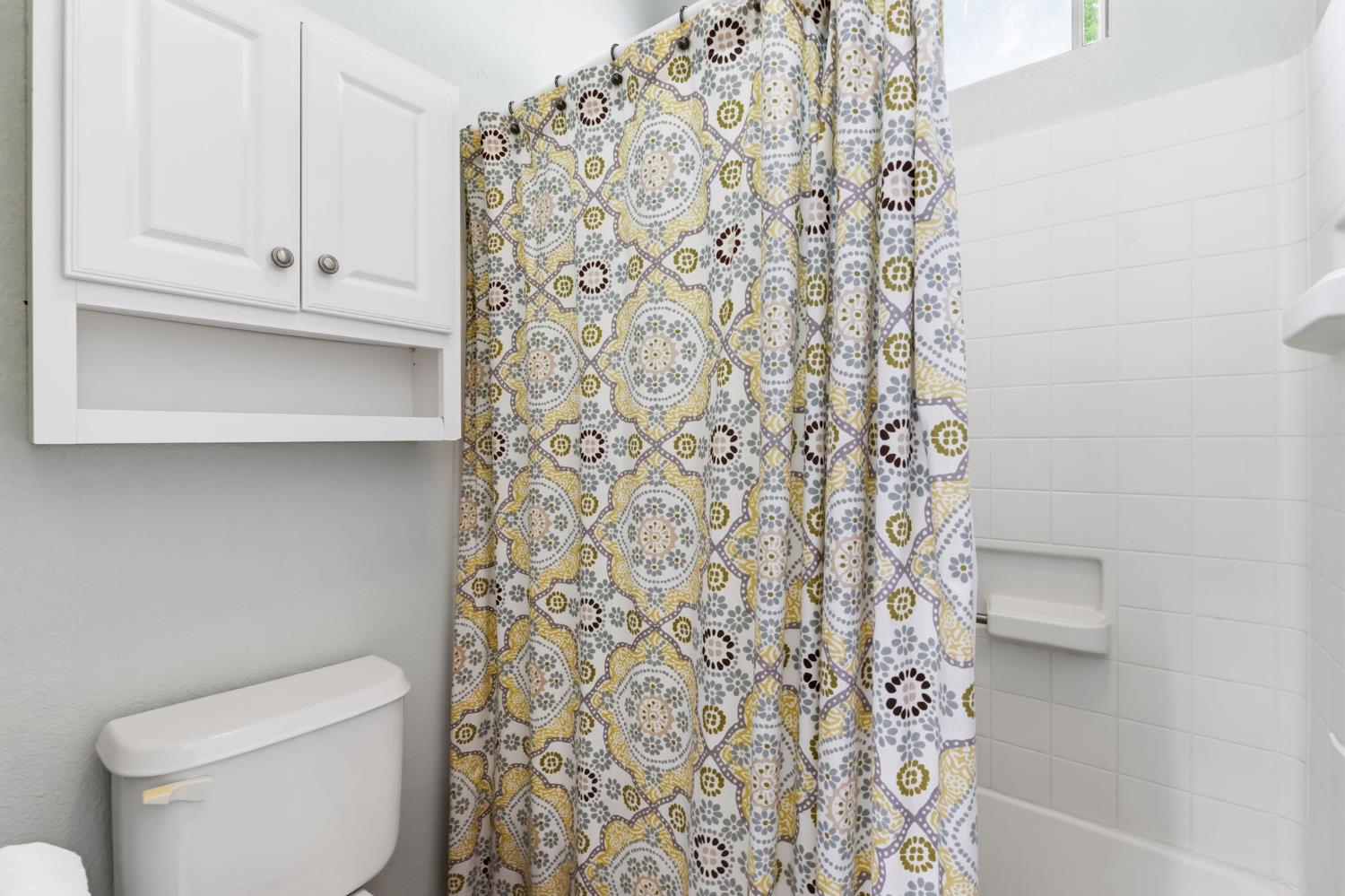 1757 Homestead Way Lemoore, CA 93245 - Photo 24 of 35 a white toilet sitting next to a shower curtain