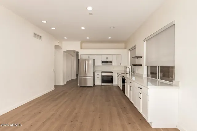 a view of a kitchen with refrigerator and stove