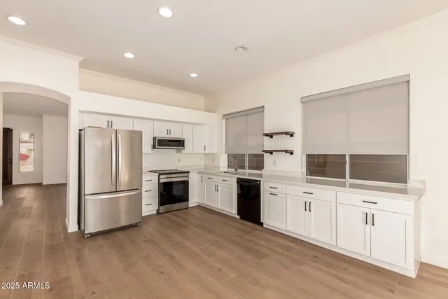a kitchen with a refrigerator sink and cabinets