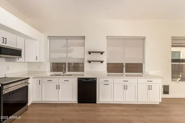 a kitchen with stainless steel appliances a stove sink and cabinets