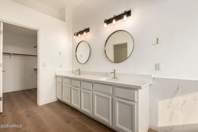 a bathroom with a double vanity sink and a mirror