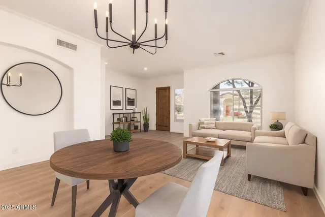 a living room with furniture a table and wooden floor