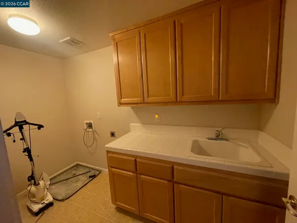a bathroom with a sink a toilet and a window