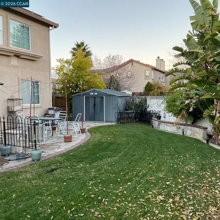a view of house with backyard and patio