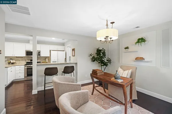 a living room with kitchen island furniture and a chandelier