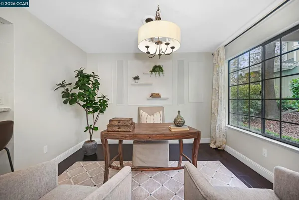 a view of a dining room with furniture a chandelier and wooden floor