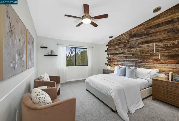 a bedroom with a bed couch and window
