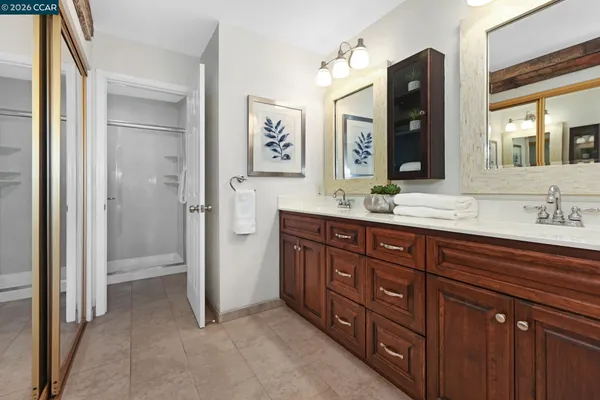 a bathroom with a double vanity sink and a mirror
