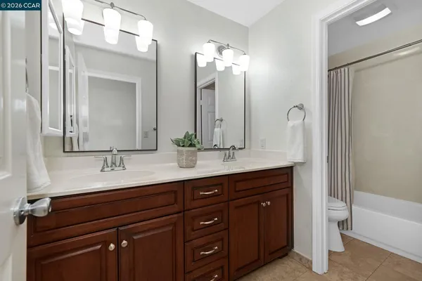 a bathroom with a double vanity sink and a mirror