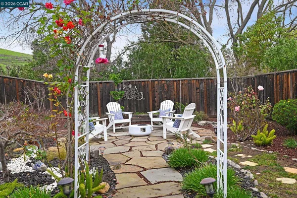 a view of a patio with table and chairs potted plants with wooden fence
