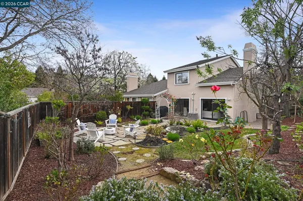 a backyard of a house with table and chairs