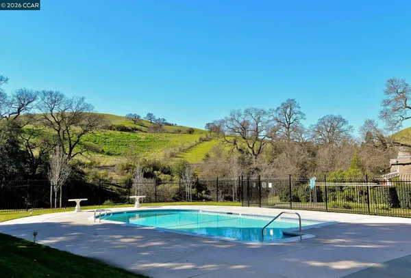 a view of yard with swimming pool and outdoor seating