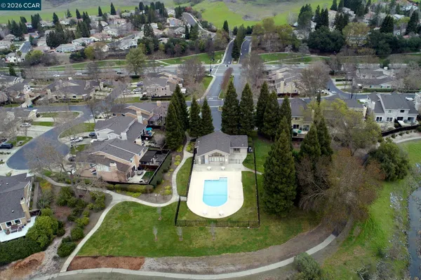 a aerial view of a house with a yard and lake view