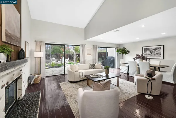 a living room with fireplace furniture and a flat screen tv