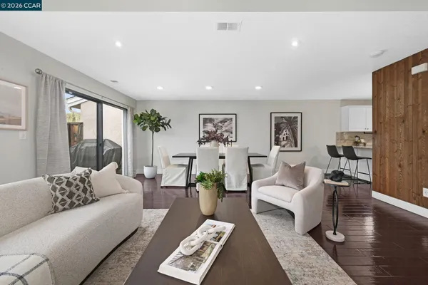 a living room with furniture and a wooden floor