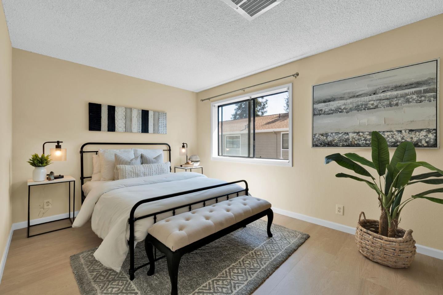244 Stonegate Circle San Jose, CA 95110 - Photo 17 of 38 a bedroom with a bed a potted plant and a window
