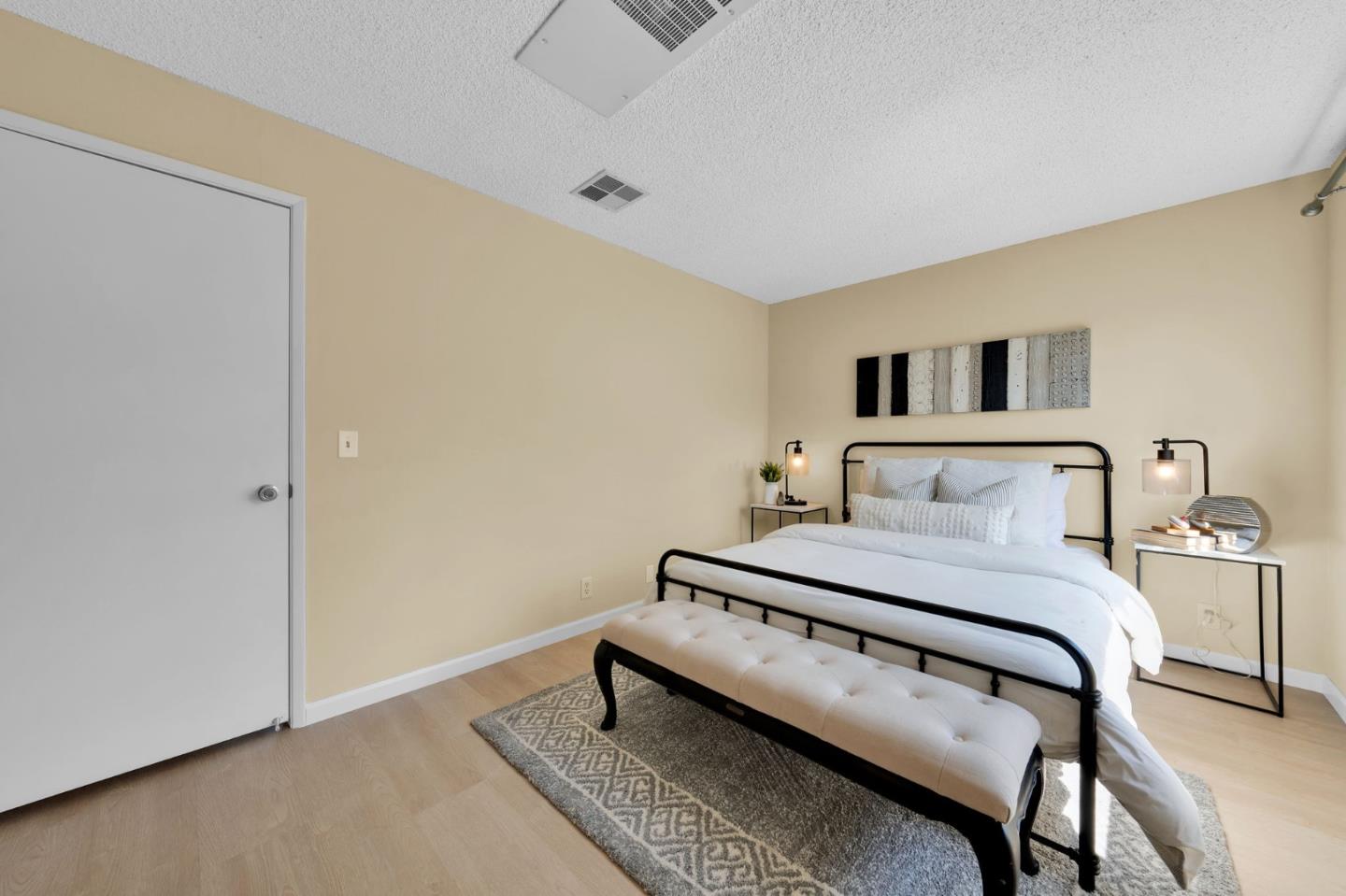 244 Stonegate Circle San Jose, CA 95110 - Photo 18 of 38 a bedroom with a bed and a night stand