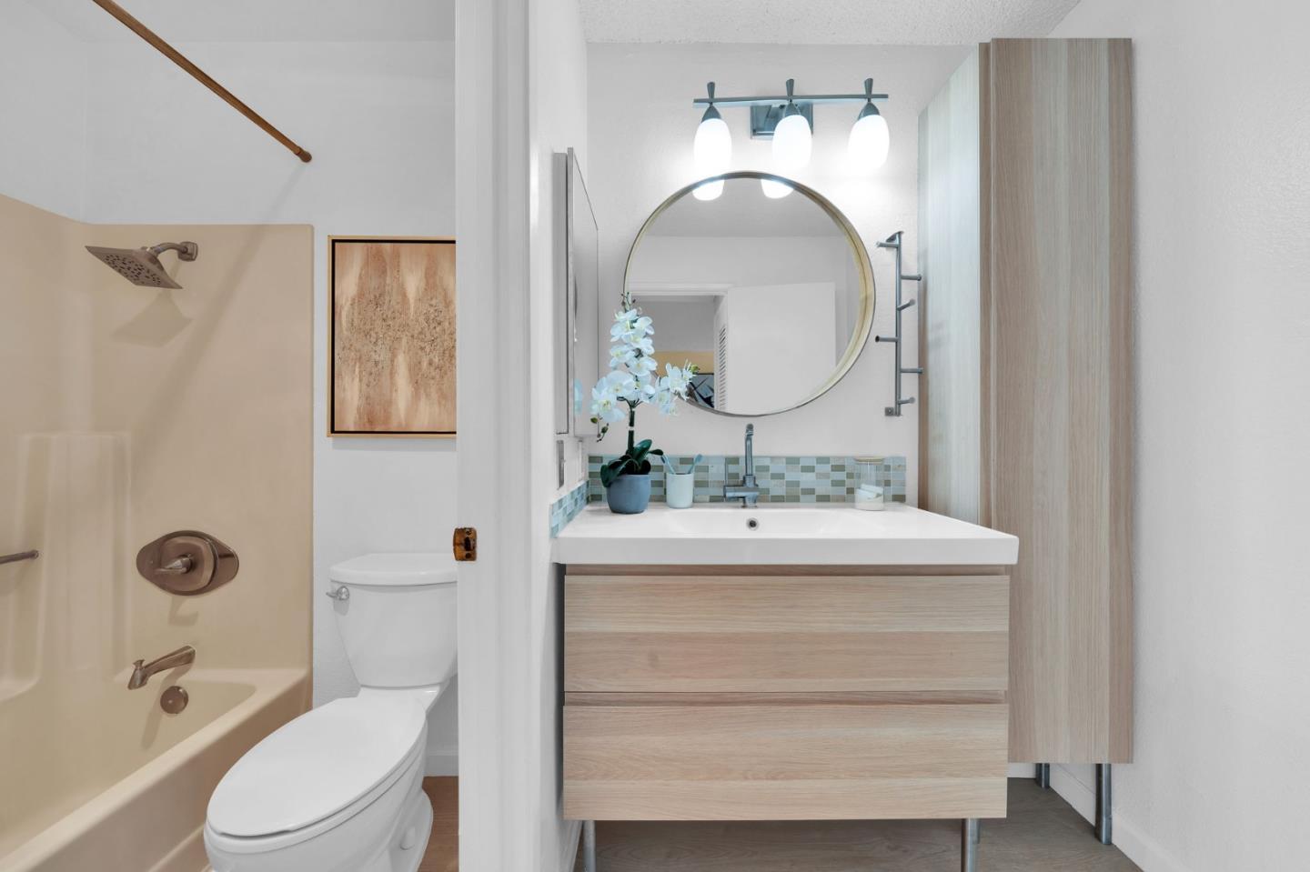 244 Stonegate Circle San Jose, CA 95110 - Photo 22 of 38 a bathroom with a toilet sink and mirror