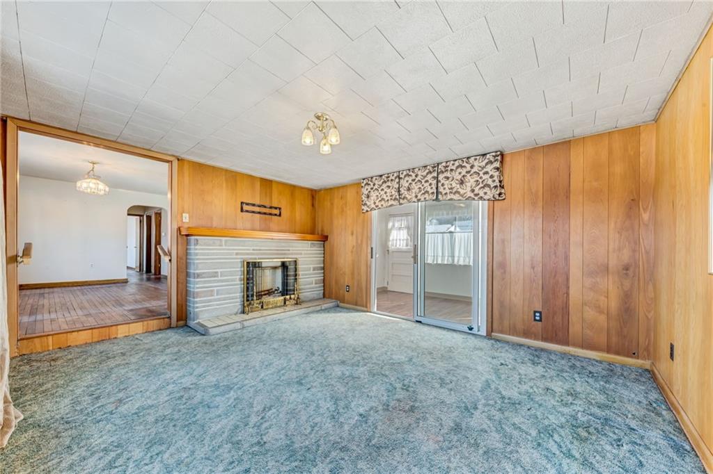 385 Deer Lane Rochester, PA 15074 - Photo 6 of 34 an empty room with fireplace and chandelier