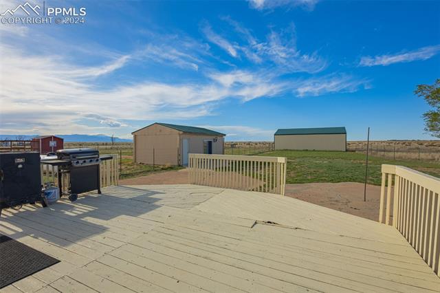 19290 Loop Road Colorado Springs, CO 80928 - Photo 29 of 39 Deck featuring an outdoor structure