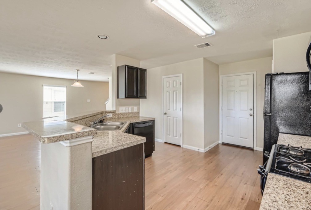 1111 Watson Crossing Way Houston, TX 77067 - Photo 2 of 8 a open kitchen with stainless steel appliances granite countertop a refrigerator stove microwave and sink