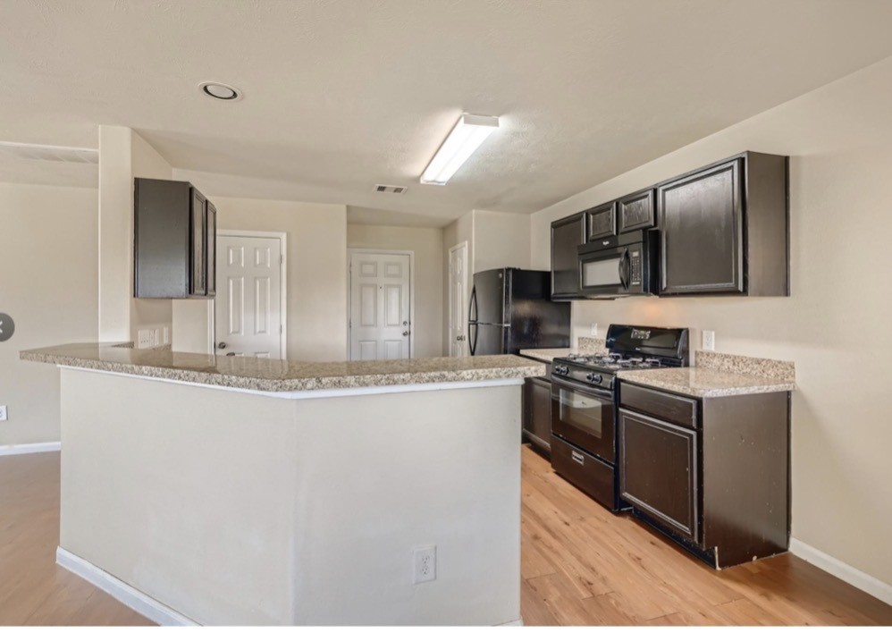 1111 Watson Crossing Way Houston, TX 77067 - Photo 3 of 8 a kitchen with stainless steel appliances granite countertop a stove top oven a sink dishwasher and a refrigerator