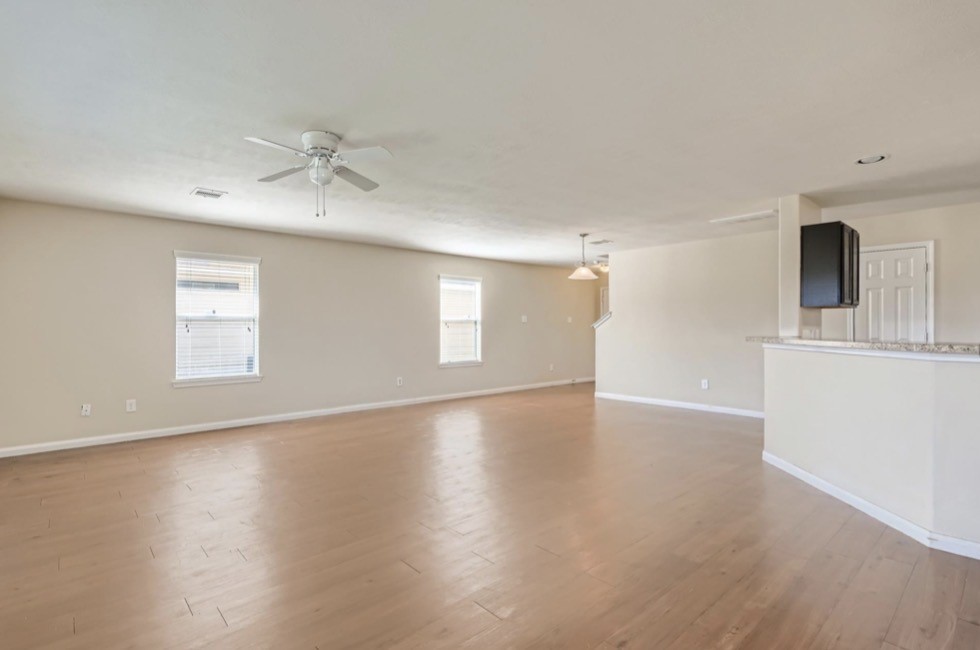 1111 Watson Crossing Way Houston, TX 77067 - Photo 5 of 8 a view of an empty room with a window and wooden floor