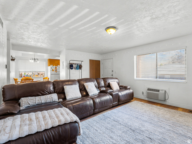 460 200 South Provo, UT 84606 - Photo 35 of 66 Living room featuring wood finished floors, a textured ceiling, and hanging lights