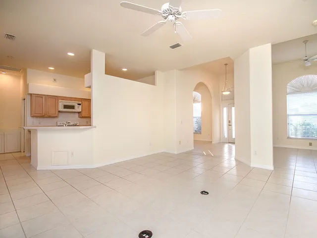 a view of a kitchen with an empty space and a window