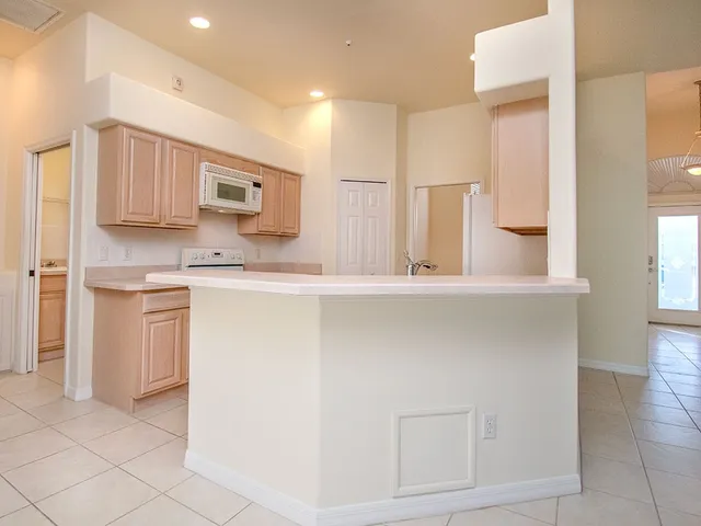 a kitchen with stainless steel appliances white cabinets and a sink