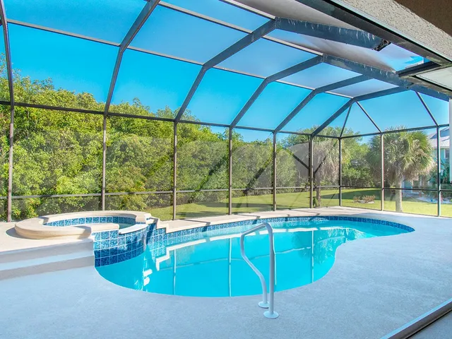 a room with pool table and chairs