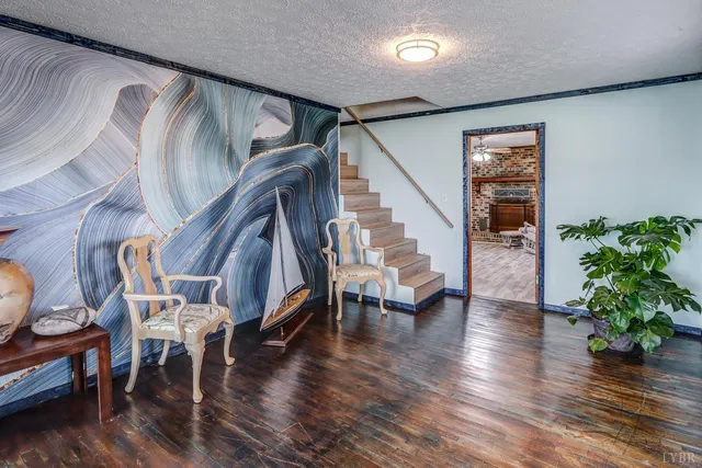 a view of entryway with wooden floor and stairs
