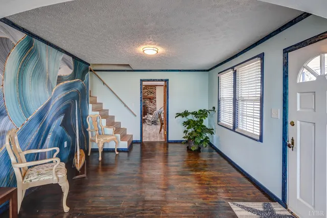 a view of an entryway with wooden floor and windows