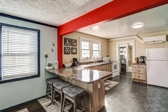 a large dining hall with stainless steel appliances granite countertop a stove and a dining table view