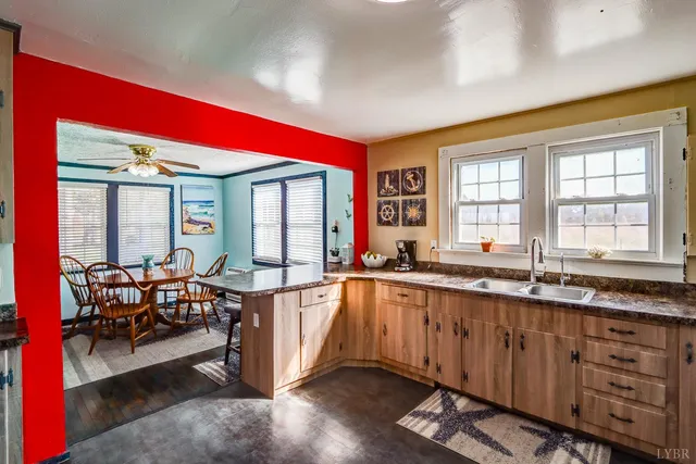 a large living room with stainless steel appliances granite countertop a sink and cabinets
