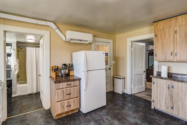 a kitchen with a refrigerator and a stove