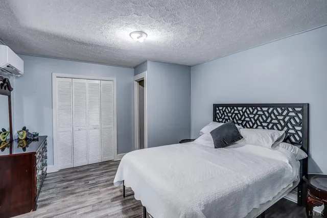 a bedroom with a bed and a potted plant
