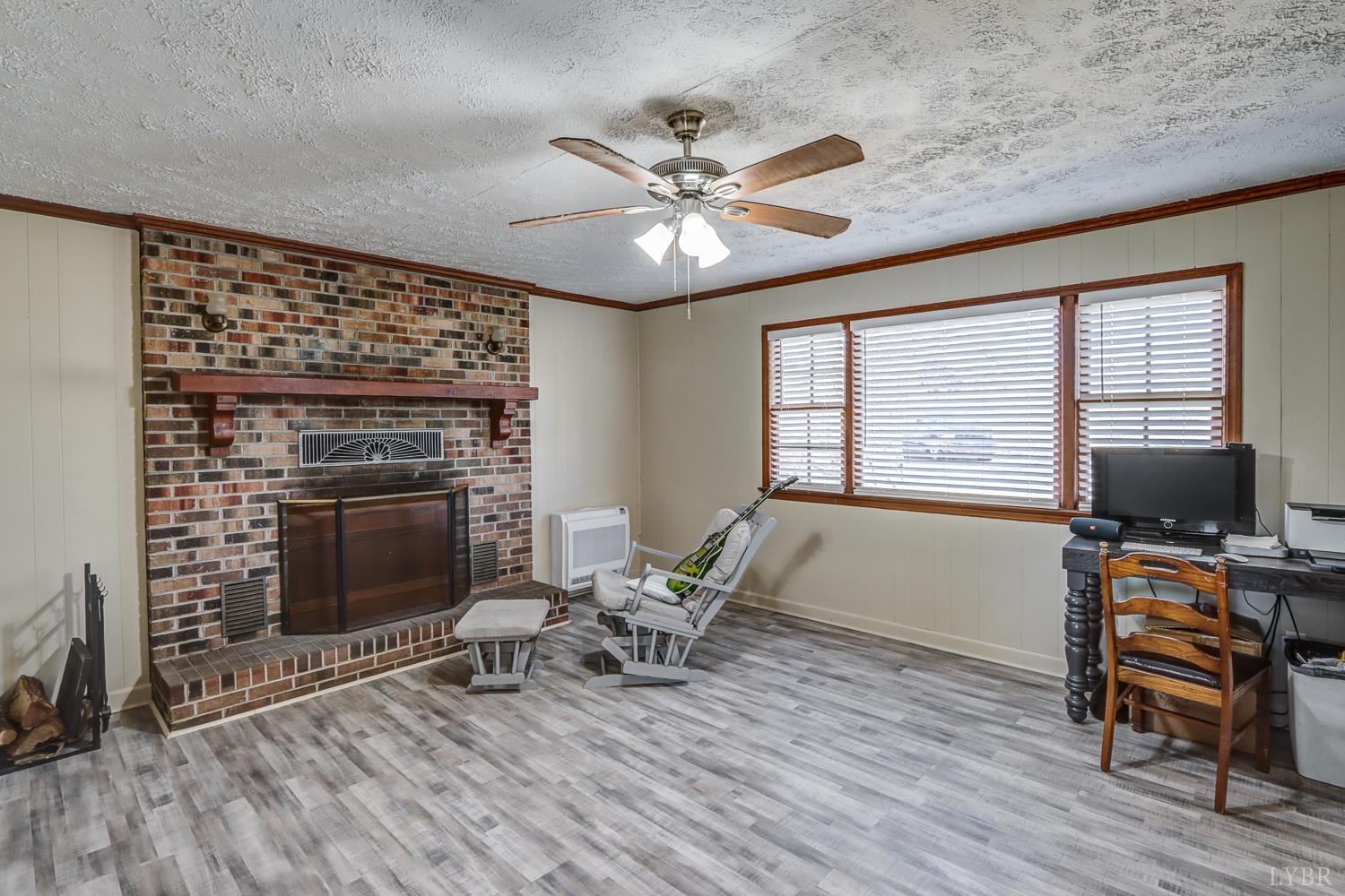 3292 Payneton Road Chatham, VA 24531 - Photo 39 of 48 a living room with furniture and a fireplace