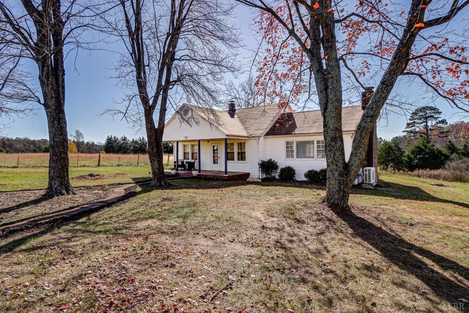 3292 Payneton Road Chatham, VA 24531 - Photo 4 of 48 a view of a large white house with a large tree next to a yard