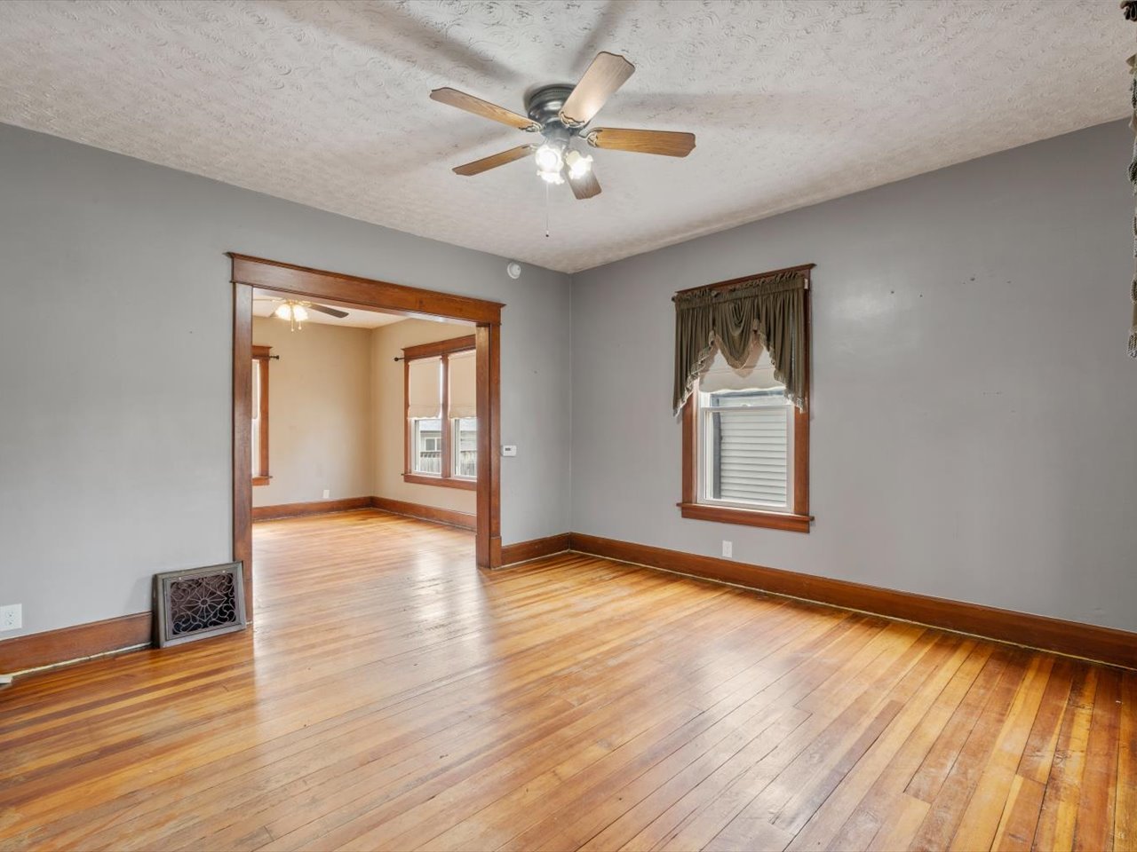 2416 21st Avenue Rock Island, IL 61201 - Photo 13 of 26 a view of an empty room with window and wooden floor