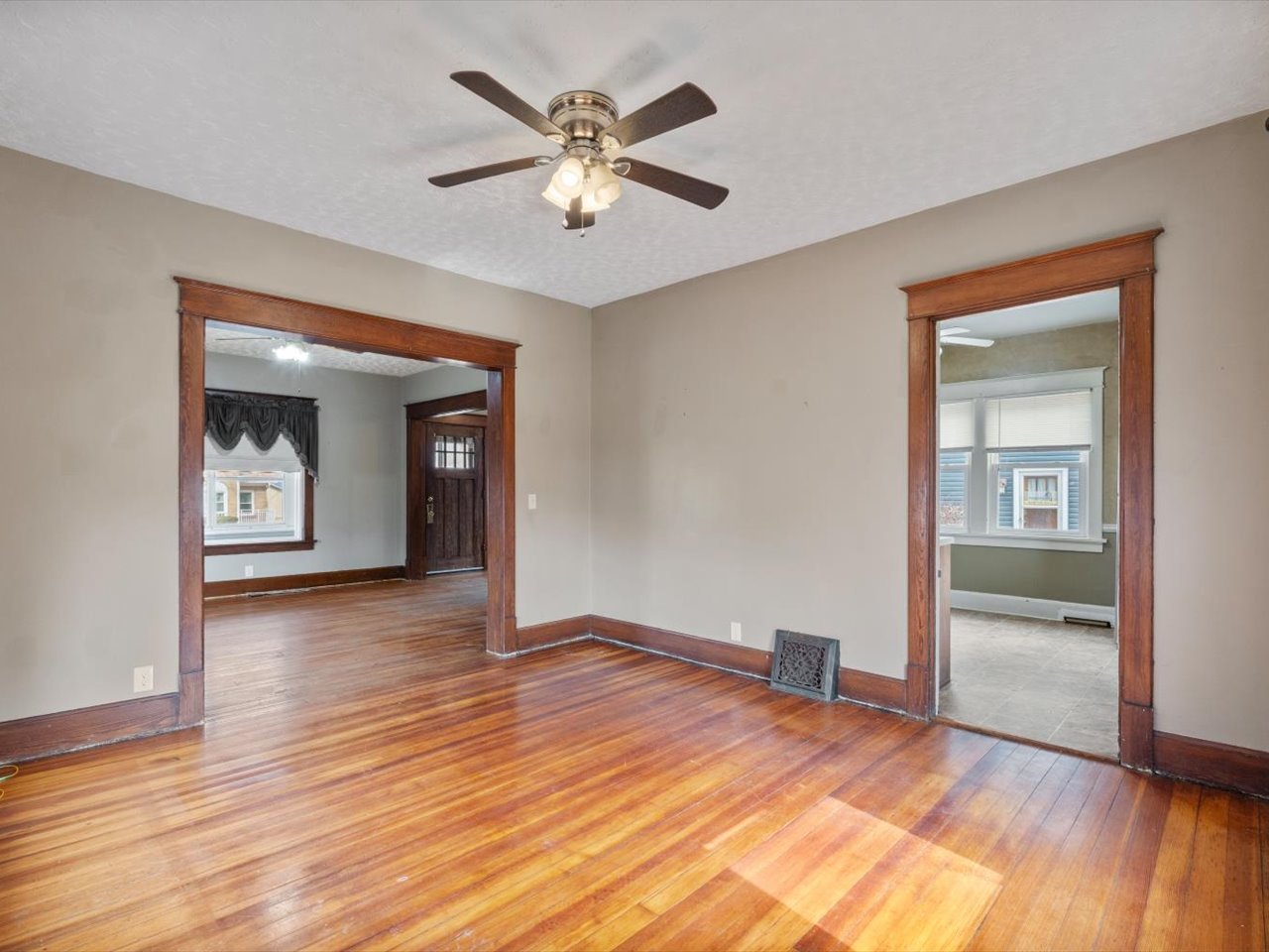 2416 21st Avenue Rock Island, IL 61201 - Photo 16 of 26 an empty room with wooden floor and a ceiling fan