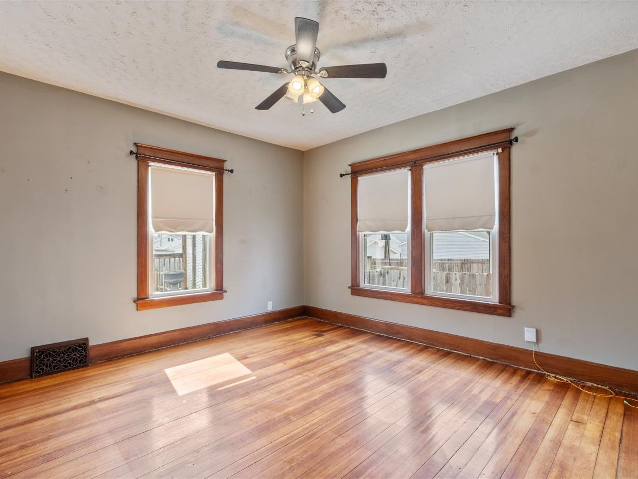 2416 21st Avenue Rock Island, IL 61201 - Photo 18 of 26 a view of an empty room with a window and wooden floor